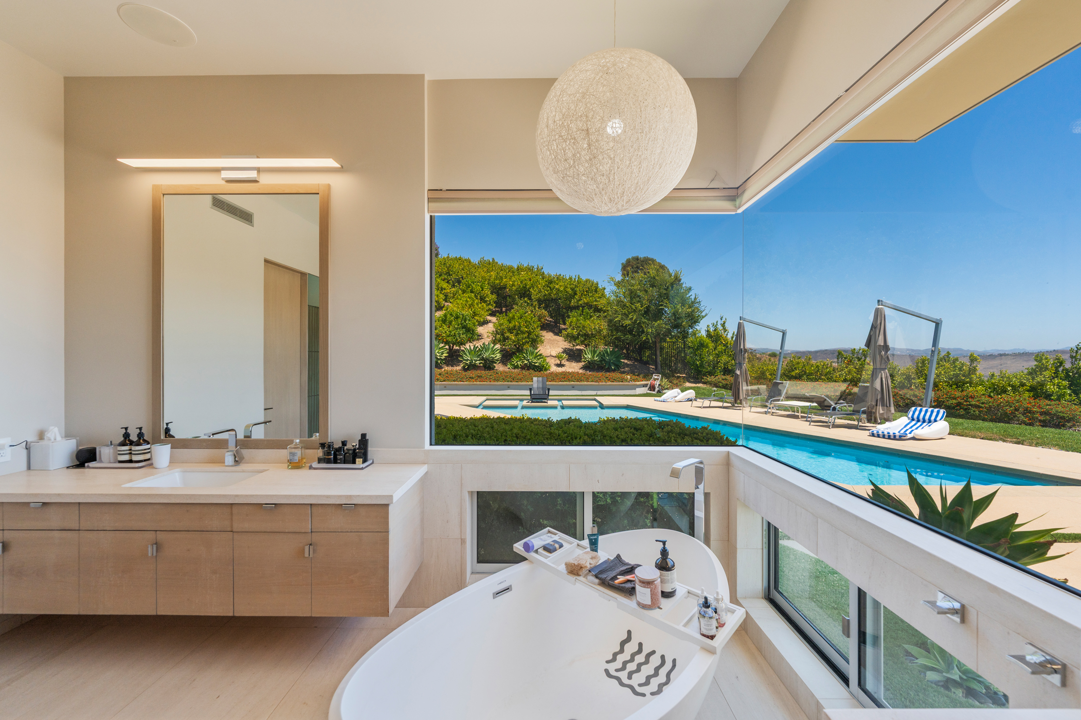 Primary bathroom with pool view